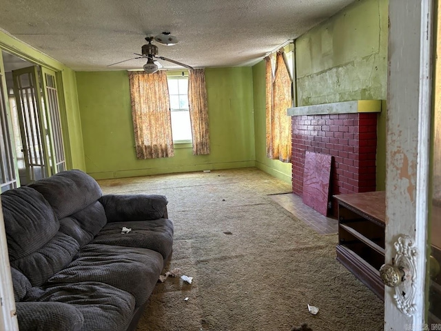 carpeted living area featuring a fireplace, ceiling fan, and a textured ceiling