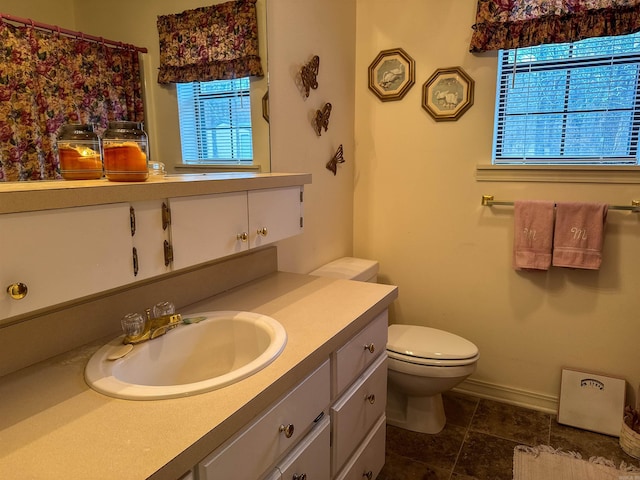 bathroom featuring tile patterned flooring, vanity, and toilet