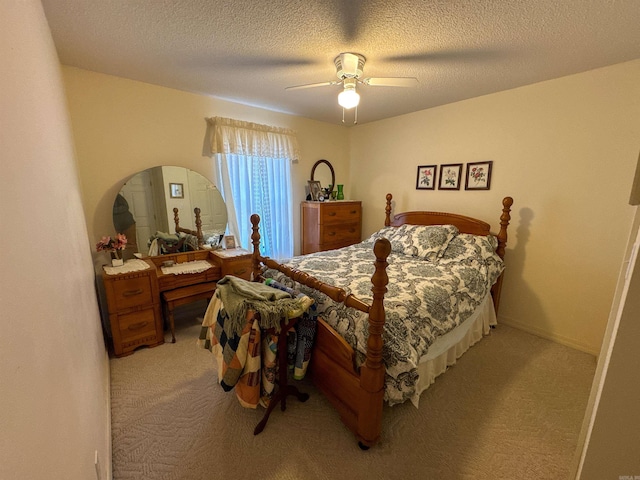 bedroom featuring a textured ceiling, ceiling fan, and light carpet