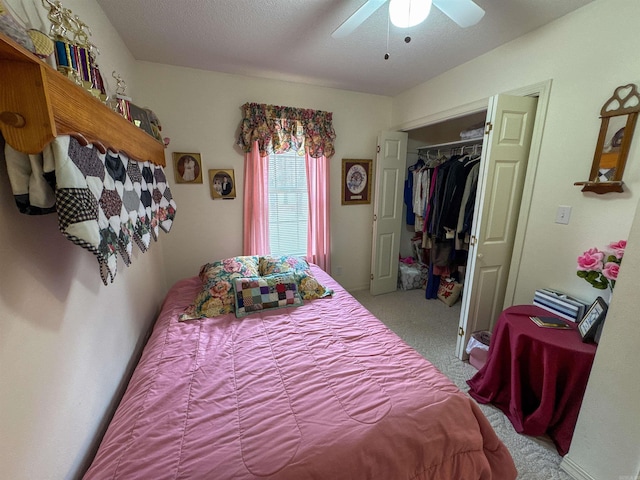 bedroom with ceiling fan, a closet, carpet floors, and a textured ceiling