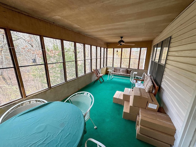 unfurnished sunroom featuring a jacuzzi and ceiling fan