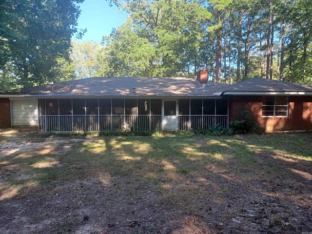 rear view of property featuring a yard