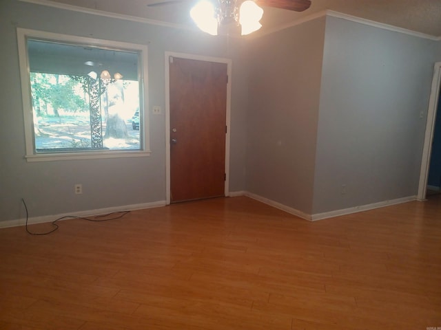 unfurnished room with hardwood / wood-style flooring, ceiling fan, and ornamental molding