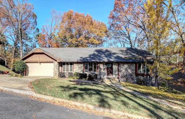 single story home featuring a garage and a front lawn