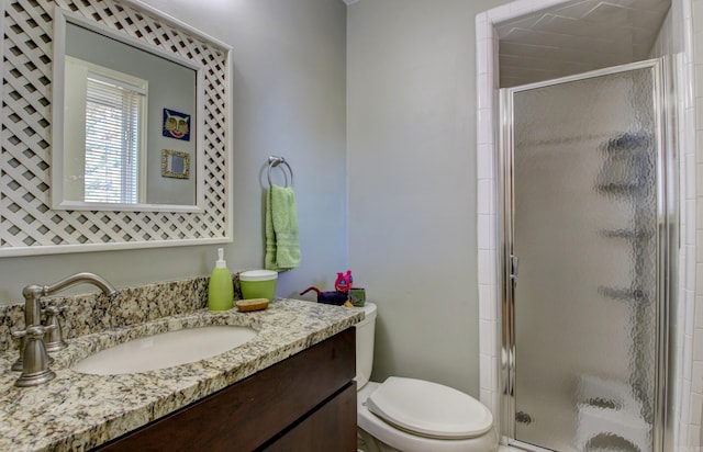 bathroom with vanity, toilet, and walk in shower