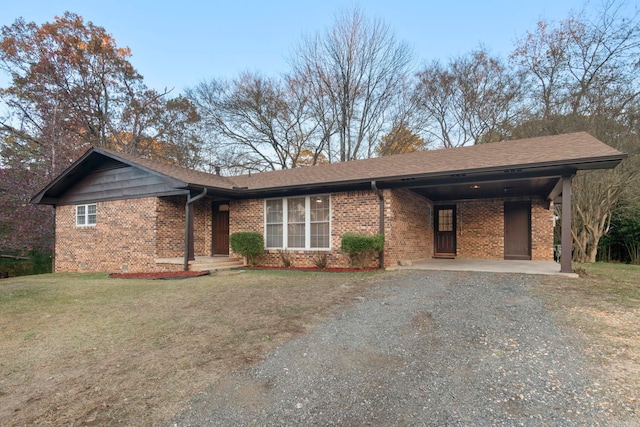 ranch-style home with a front lawn and a carport