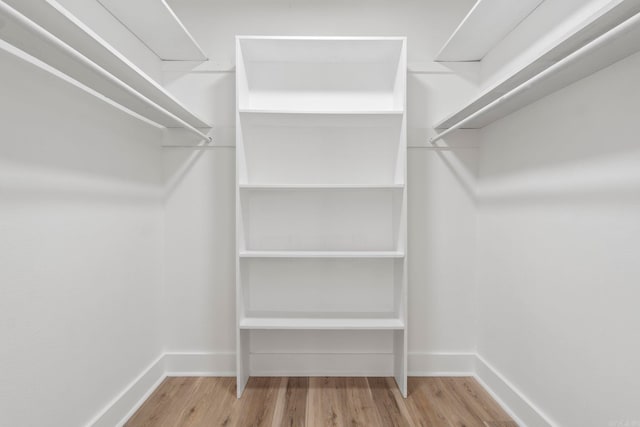 walk in closet featuring light hardwood / wood-style flooring