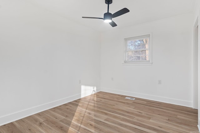 empty room featuring ceiling fan and light hardwood / wood-style flooring