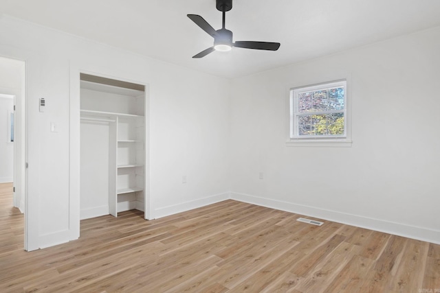 unfurnished bedroom with light wood-type flooring, a closet, and ceiling fan