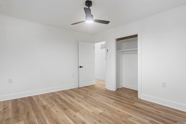 unfurnished bedroom featuring ceiling fan, light hardwood / wood-style floors, and a closet