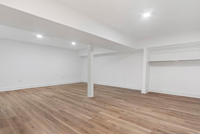 basement with light hardwood / wood-style flooring