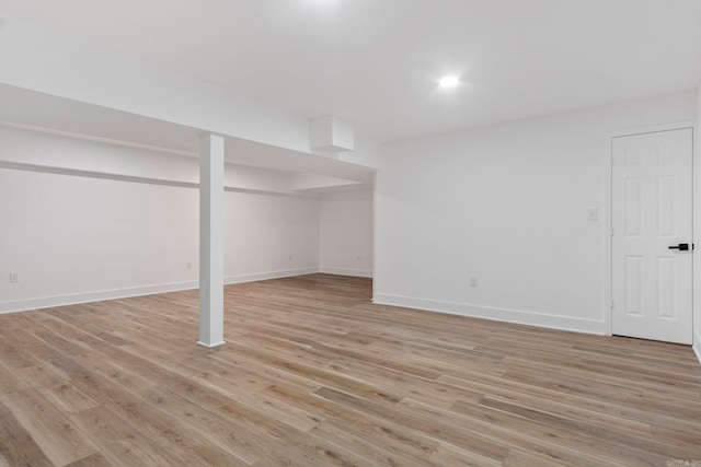 basement with light hardwood / wood-style flooring