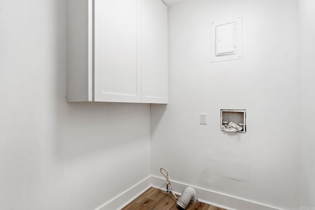 laundry area featuring hardwood / wood-style floors, cabinets, and hookup for a washing machine