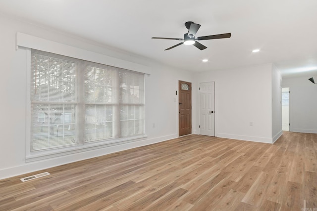 unfurnished living room featuring ceiling fan and light wood-type flooring