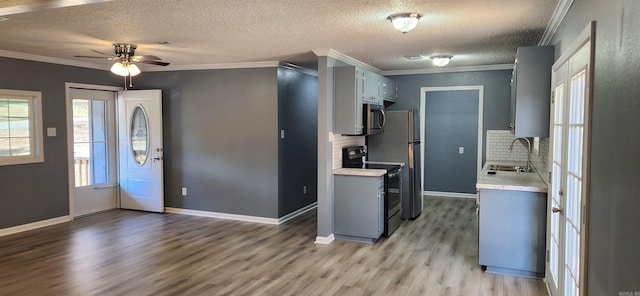 kitchen featuring decorative backsplash, ceiling fan, sink, hardwood / wood-style flooring, and black / electric stove