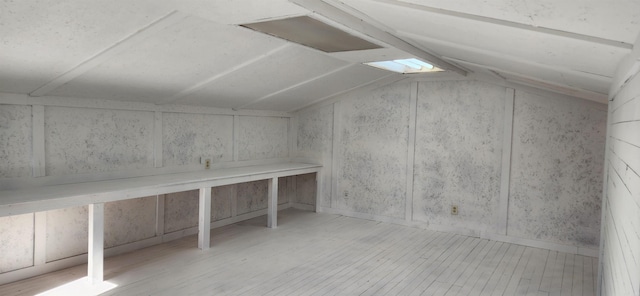 bonus room with vaulted ceiling with skylight