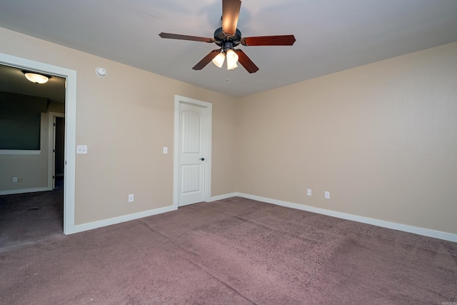 carpeted empty room featuring ceiling fan