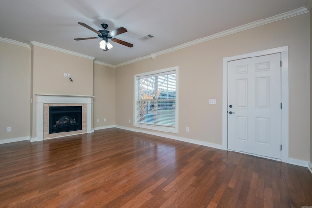 unfurnished living room with dark hardwood / wood-style flooring, ornamental molding, and a fireplace