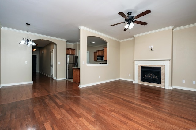 unfurnished living room featuring dark hardwood / wood-style flooring, crown molding, and a tile fireplace