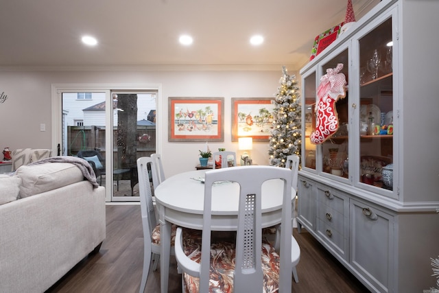 dining room with ornamental molding and dark wood-type flooring