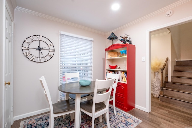 dining room with hardwood / wood-style floors and ornamental molding