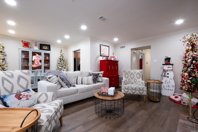 living room featuring dark hardwood / wood-style flooring and ornamental molding