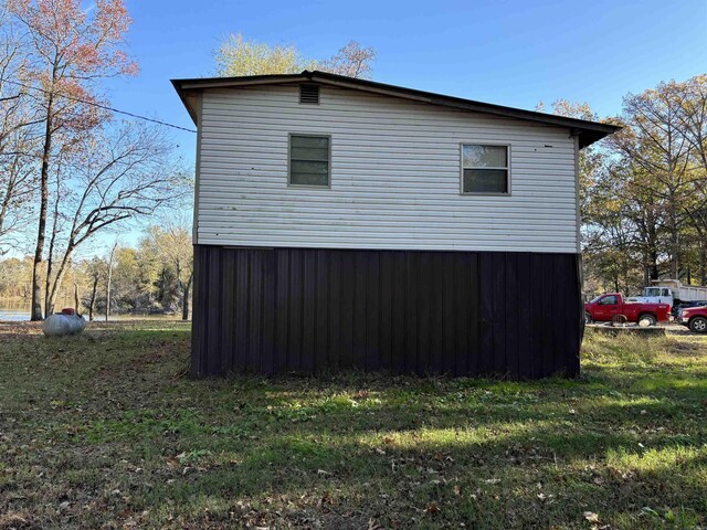 view of side of property with a lawn