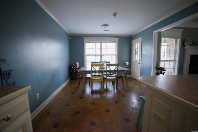 tiled dining room featuring ornamental molding