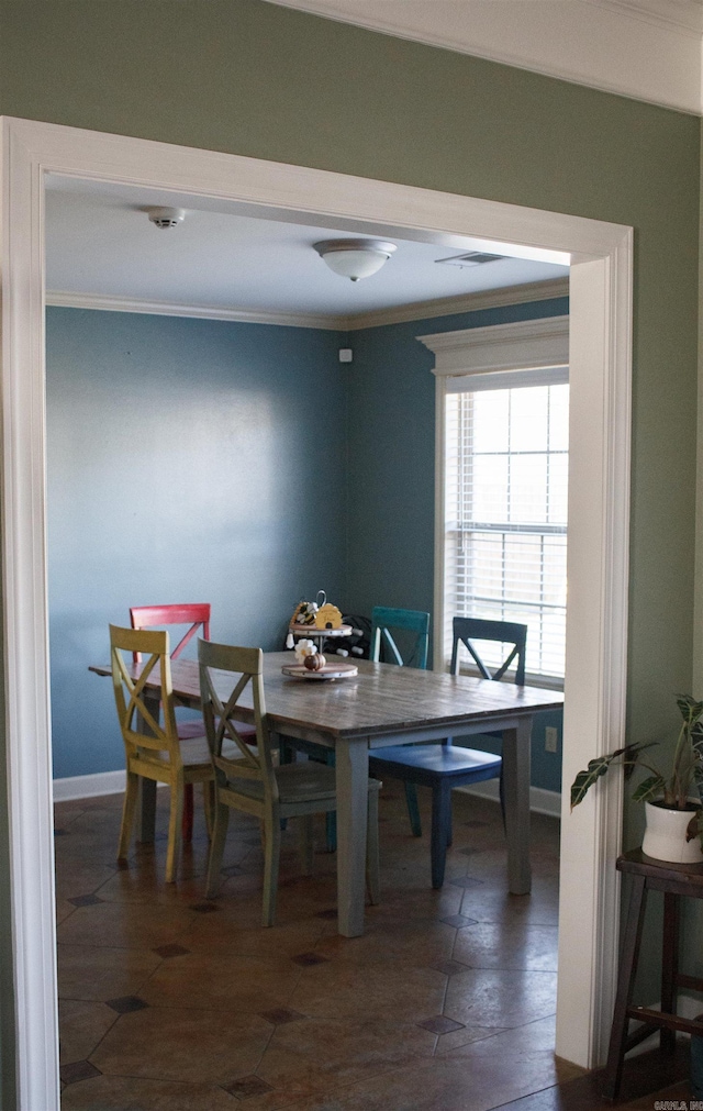 dining room featuring crown molding