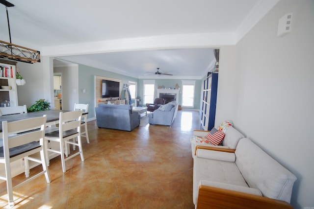 living room with ceiling fan and crown molding