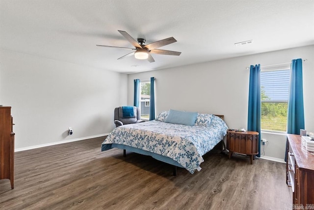 bedroom featuring ceiling fan and dark wood-type flooring