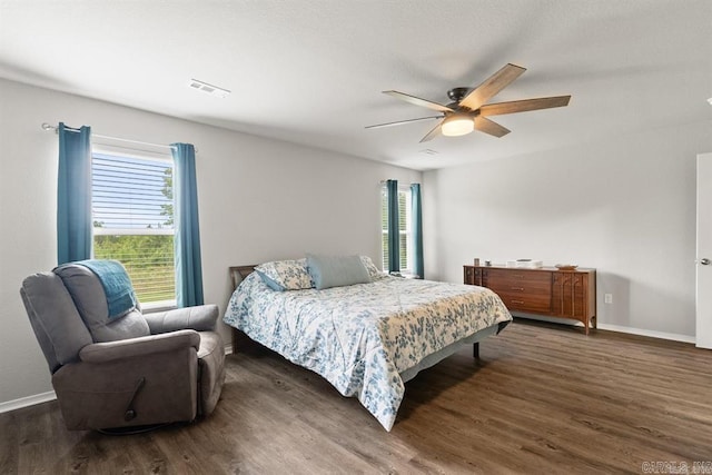 bedroom with ceiling fan and dark hardwood / wood-style floors