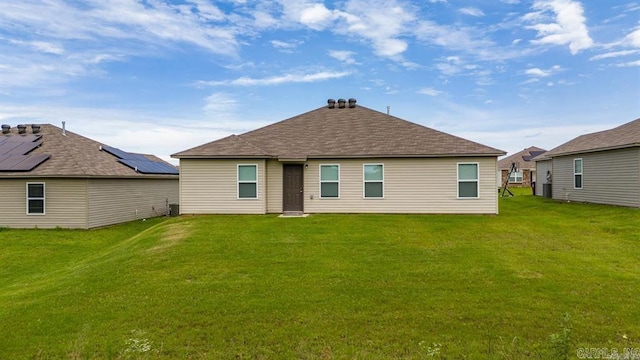 rear view of house with a lawn