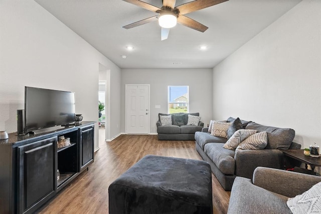 living room with light hardwood / wood-style floors and ceiling fan