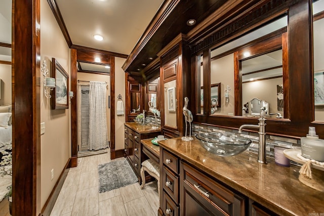 interior space featuring walk in shower, tile patterned flooring, vanity, and ornamental molding