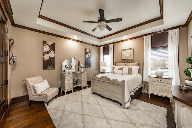 bedroom with ornamental molding, a raised ceiling, ceiling fan, and dark wood-type flooring