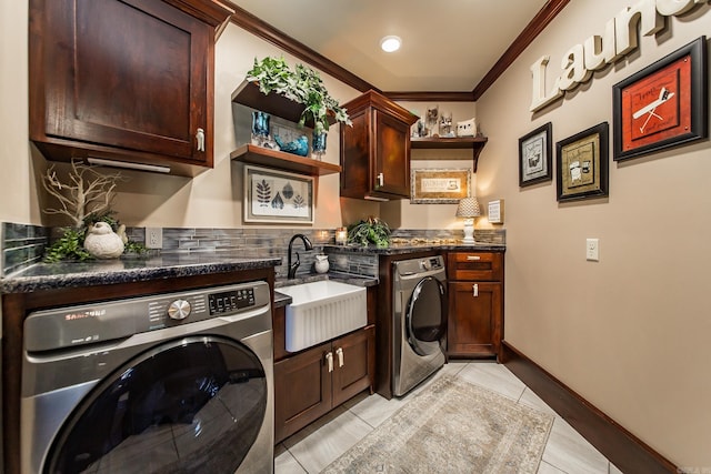 laundry area with cabinets, sink, independent washer and dryer, ornamental molding, and light tile patterned floors