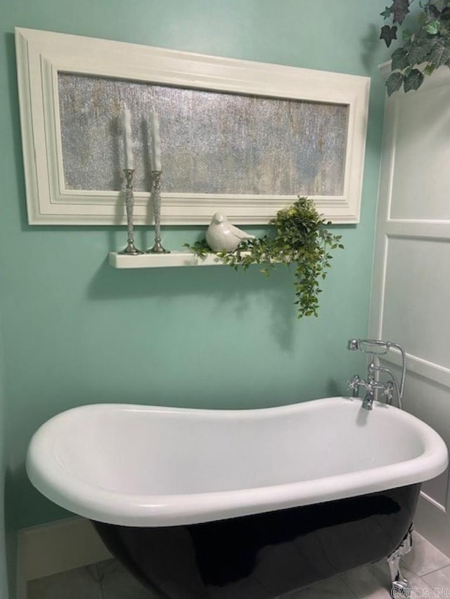 bathroom with tile patterned flooring and a washtub