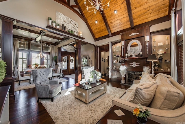 living room featuring dark hardwood / wood-style flooring, high vaulted ceiling, and an inviting chandelier