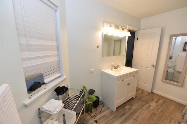 bathroom featuring hardwood / wood-style flooring and vanity