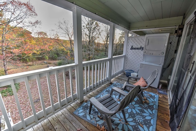 wooden deck with stacked washing maching and dryer