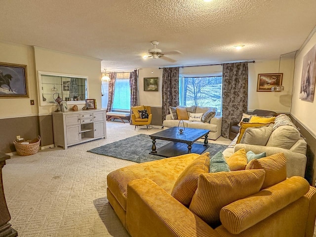 living room featuring ceiling fan, light colored carpet, and a textured ceiling