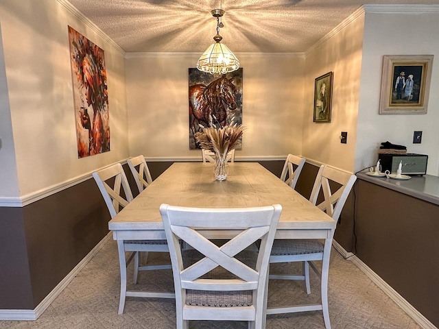 dining area featuring a chandelier, a textured ceiling, and ornamental molding