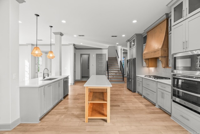 kitchen featuring a kitchen island, a sink, appliances with stainless steel finishes, custom exhaust hood, and open shelves