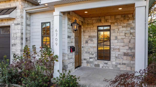 doorway to property with a garage