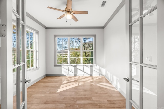 unfurnished sunroom with a ceiling fan, french doors, and visible vents