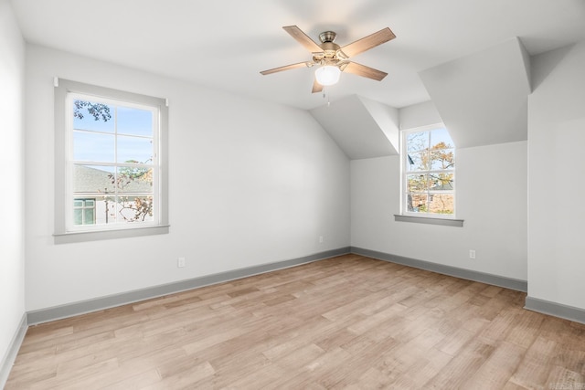 bonus room with vaulted ceiling, light hardwood / wood-style flooring, a wealth of natural light, and ceiling fan