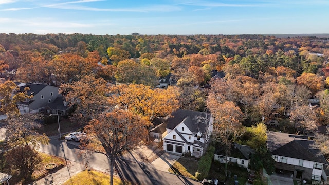 drone / aerial view with a wooded view