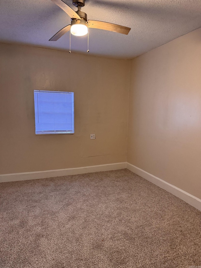 spare room featuring a textured ceiling, carpet floors, and ceiling fan