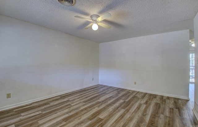 unfurnished room featuring ceiling fan, a textured ceiling, and light wood-type flooring